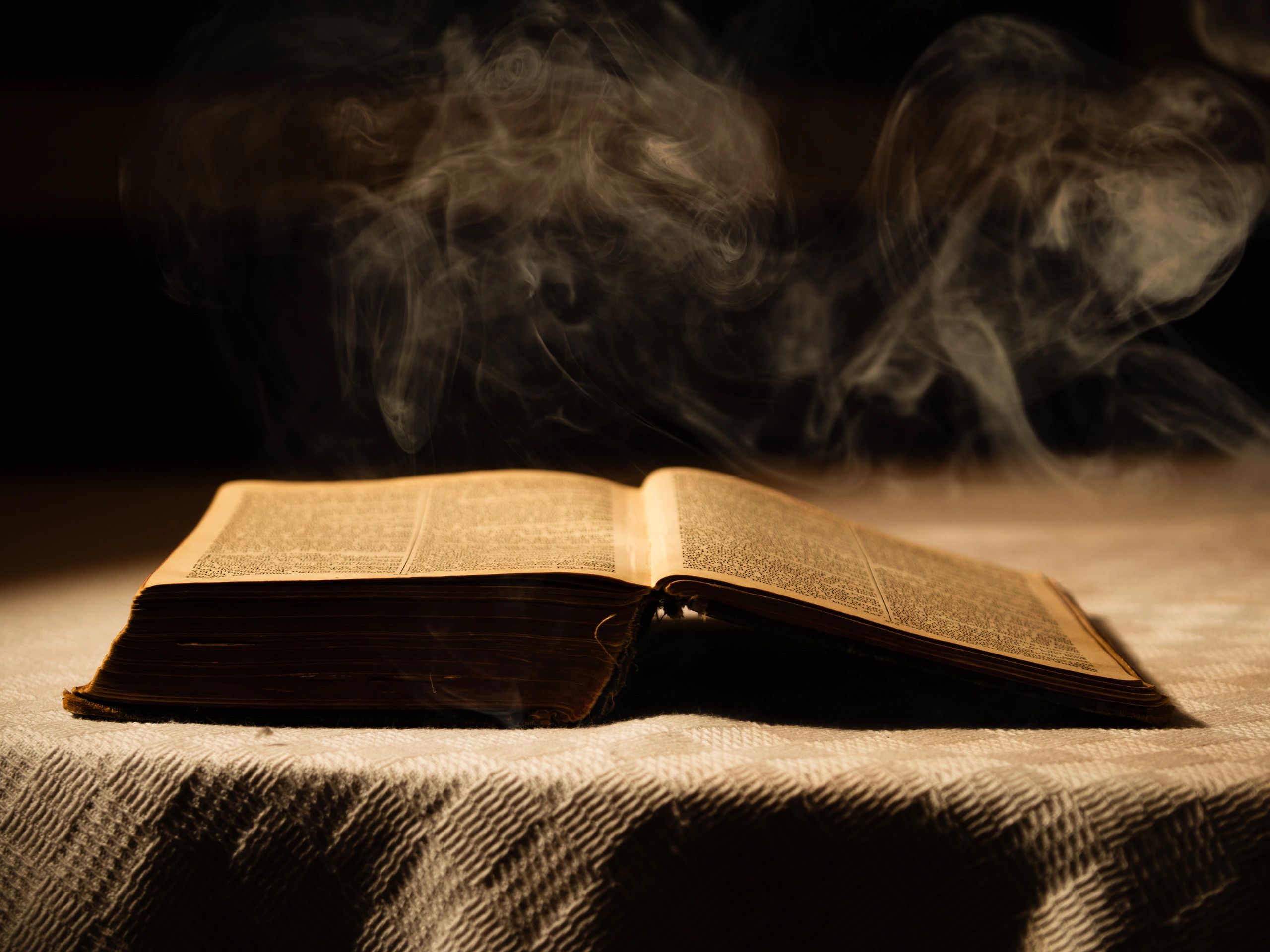 Open book with dramatic lighting representing private study